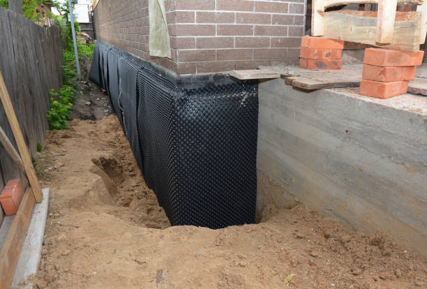 SJ Waterproofing Pros technician performing targeted Waterproofing assessment in Hatley, WI